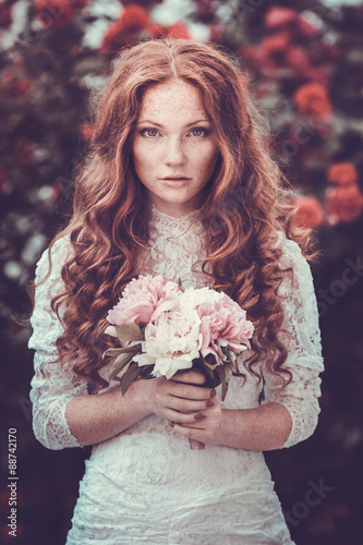 фотографія Portrait of young woman in the spring time. Almond flowers bloss