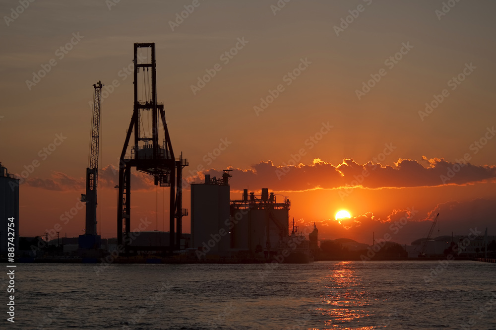 Port Miami at sunset with cargo crane silhouette horizontal orientation
