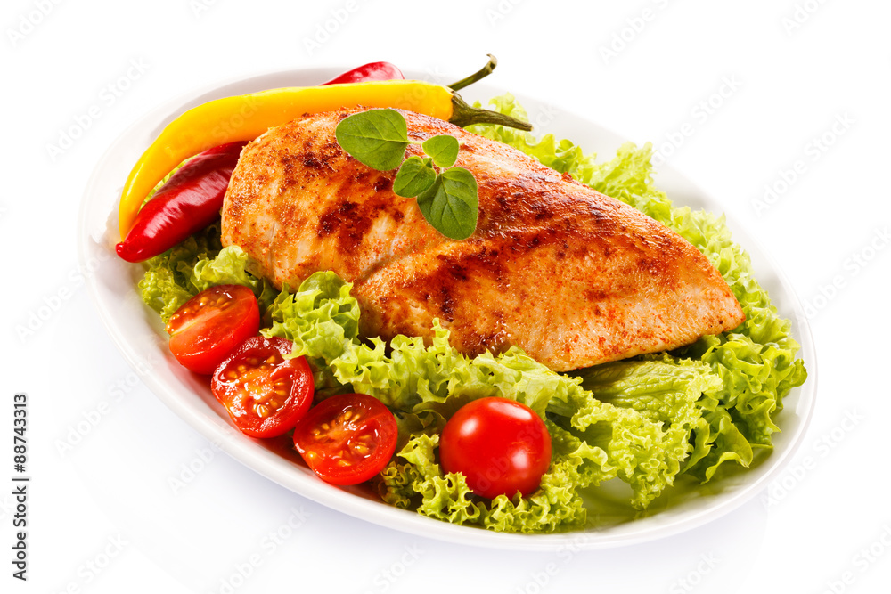 Roast chicken fillet and vegetables on white background Roast chicken fillet and vegetables on white background