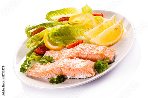Roasted salmon and vegetables on white background