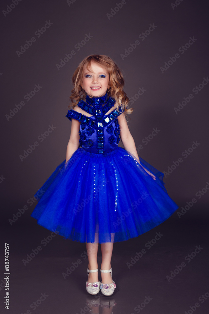 Portrait of a beautiful young girl wearing a fancy blue party gown dress, in studio Portrait of a beautiful young girl wearing a fancy blue party gown dress, in studio