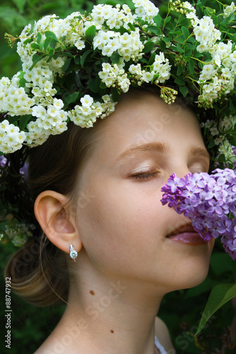 The youth, tender young girl with white flowers hairstyle photo