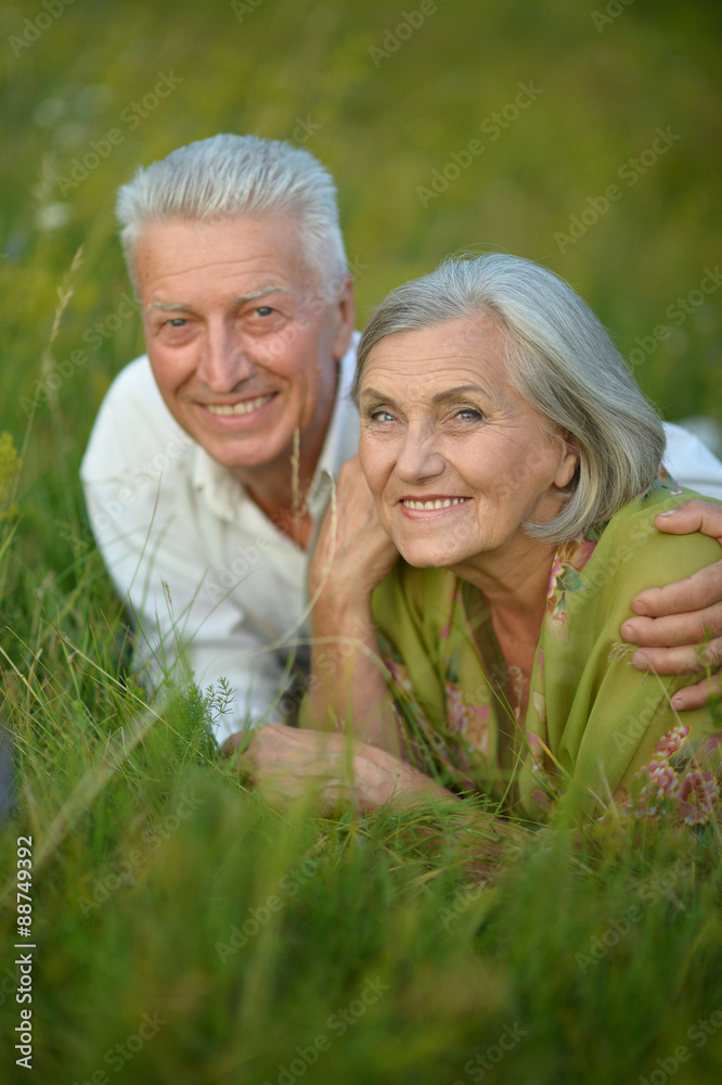 Senior couple lying on grass Senior couple lying on grass
