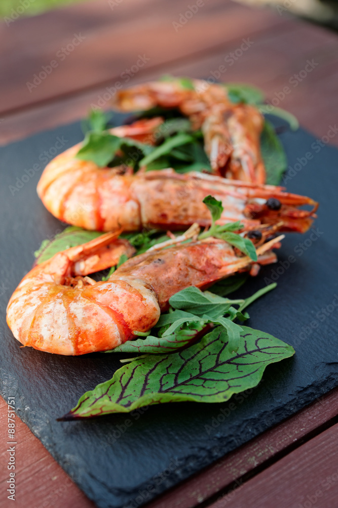 Grilled shrimps on slate plate