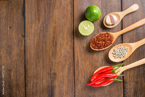 Red chilli, garlic and lemon on wooden background