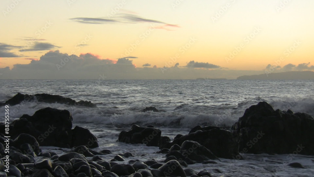 Atlantic ocean waves splash against rocks before sunrise in the early ...