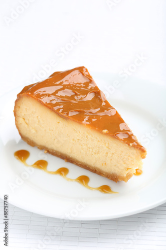 Fresh and tasty caramel cheesecake on white plate