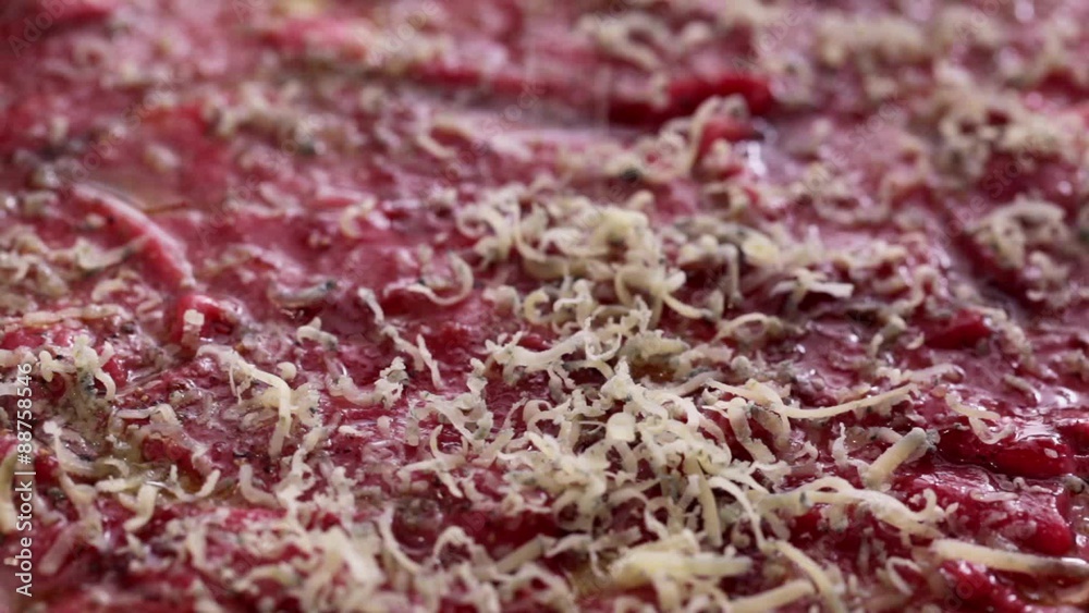 HD 1080 close up: Meat slices sprinkled with grated hard cheese HD 1080 close up: Meat slices sprinkled with grated hard cheese