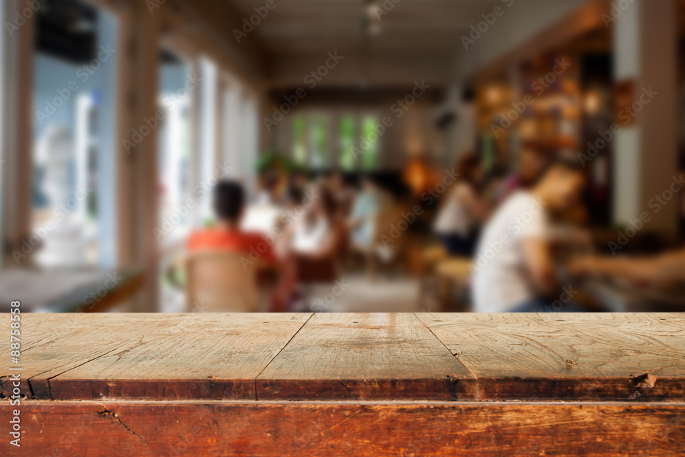 Empty wooden table and blurred people in cafe background Empty wooden table and blurred people in cafe background