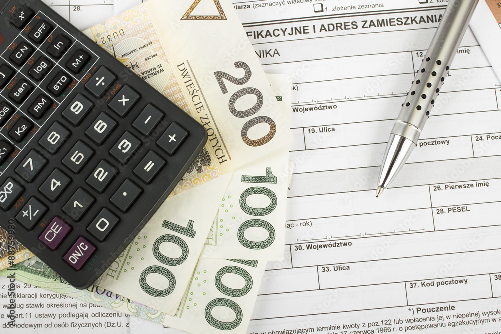 Filling in polish individual income tax form PIT with money and pen Filling in polish individual income tax form PIT with money and pen