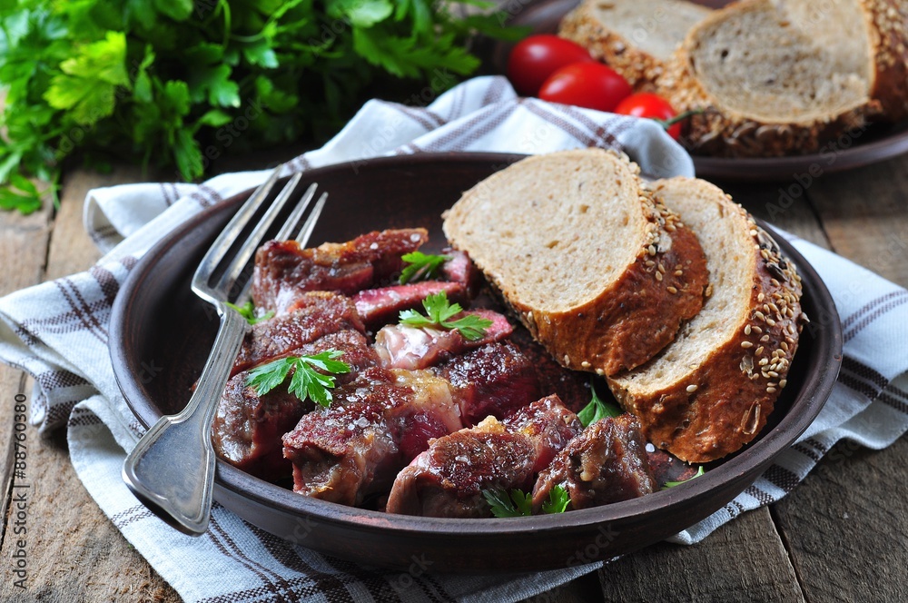 Delicious juicy rare beef steak with rye bread bran Delicious juicy rare beef steak with rye bread bran