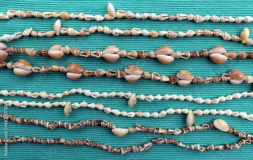Cowrie shell necklaces with a blue background (symbol of money and wealth)