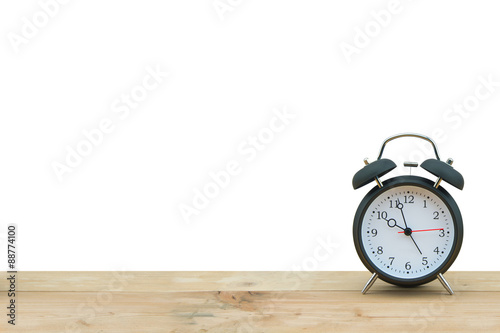 Alarm clock isolated on wooden floor