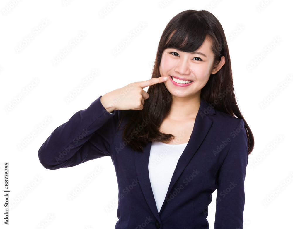 Young Businesswoman with finger point to her teeth Young Businesswoman with finger point to her teeth