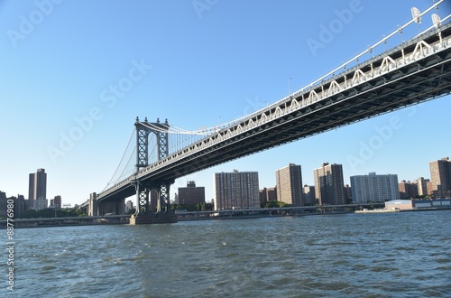 New York Bridge over Hudson River in New York, USA with blue sky background and Skyscrapers in this summer setting. © Rexi Video