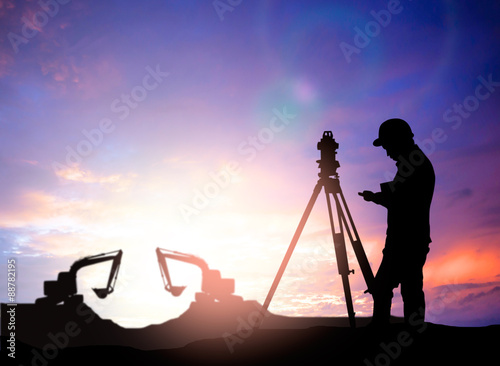 silhouette survey engineer working  in a building site over Blur