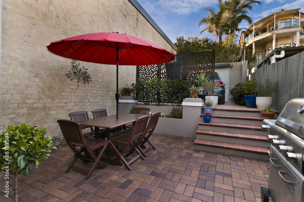 Backyard cozy patio area with wicker furniture set - obrazy, fototapety, plakaty 