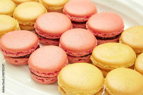 Yellow and Orange Macaroons on White Plate