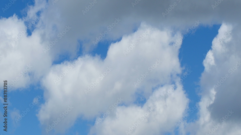 White clouds flying on blue sky, time lapse.
White clouds flying on blue sky, time lapse.