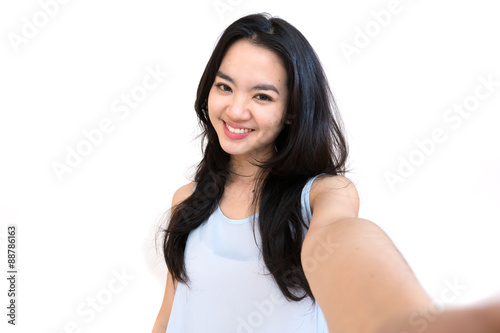 An asian woman taking self portrait isolated on white