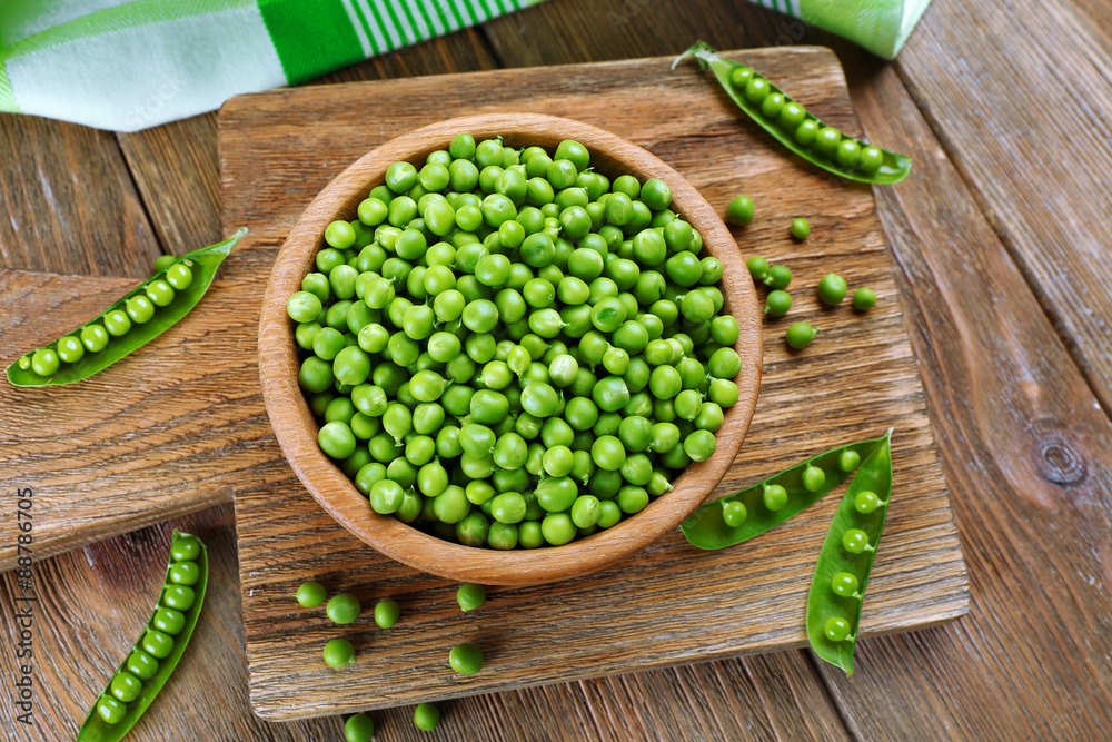 Fresh green peas in bowl on table close up Fresh green peas in bowl on table close up