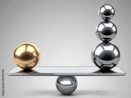 Balance between large gold and steel spheres.