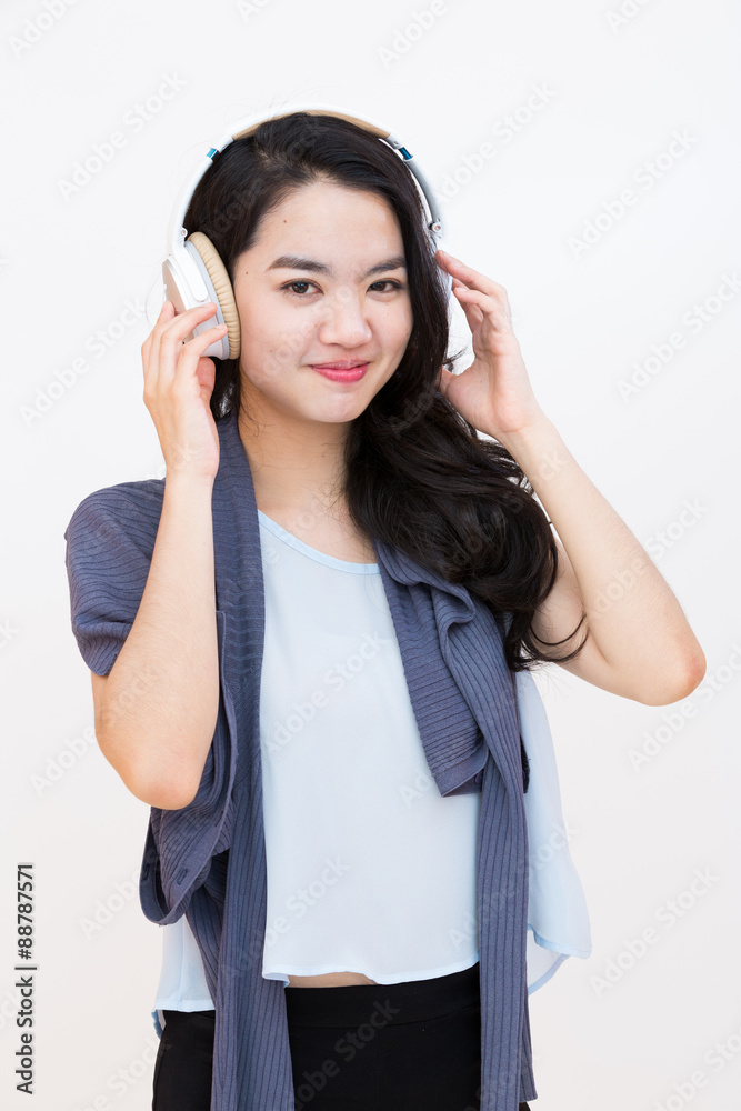 Young asian student enjoying music in casual clothes Young asian student enjoying music in casual clothes