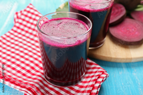 Glasses of beet juice with vegetables on table close up