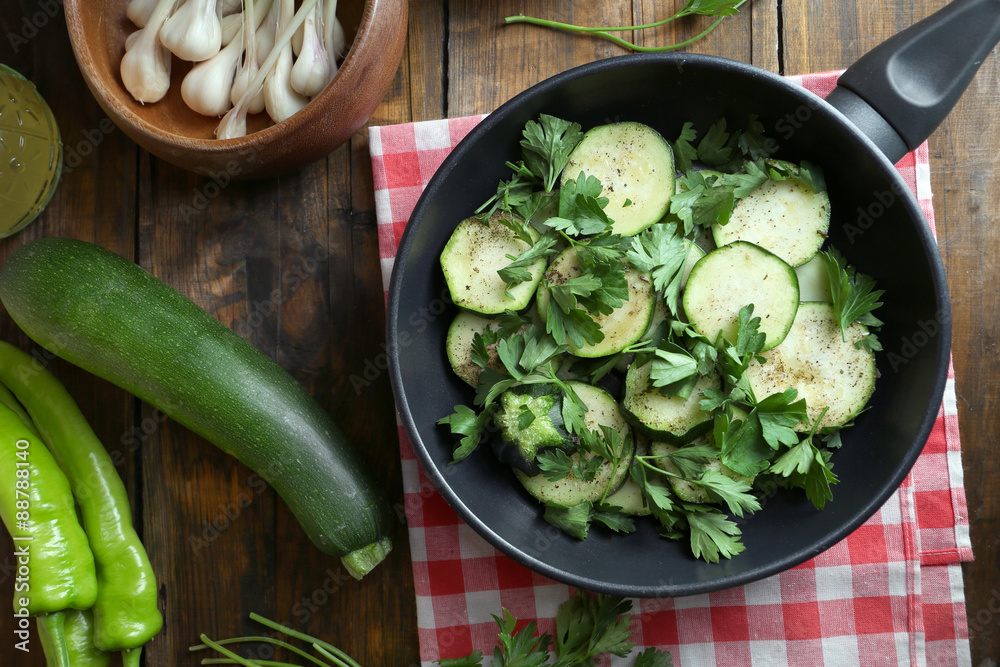 Sliced zucchini in pan on table, top view Sliced zucchini in pan on table, top view