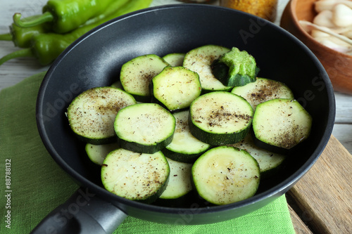 Sliced zucchini in pan on table, closeup