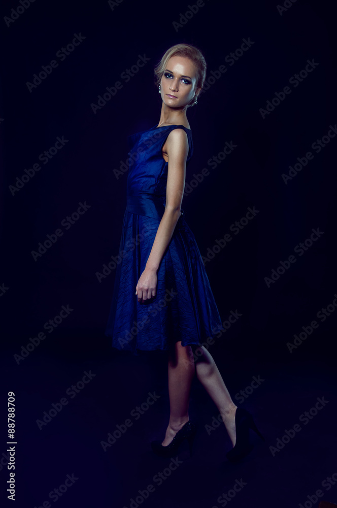 Studio portrait of beautiful blonde woman in dark blue dress Studio portrait of beautiful blonde woman in dark blue dress