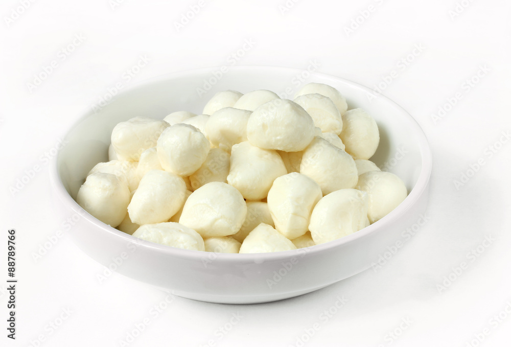 Mini mozzarella in a white bowl on a white background Mini mozzarella in a white bowl on a white background