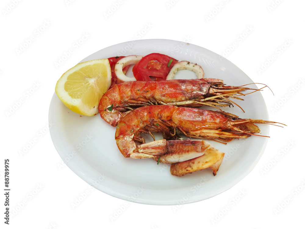 fresh shrimp and lemon on dish isolated over white
