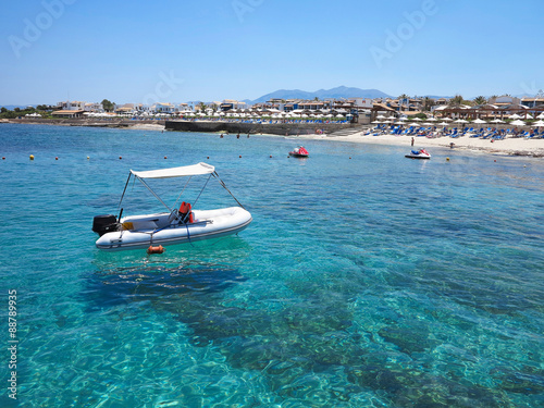 Boat over clear water on Crete coast, Greece © alexrow