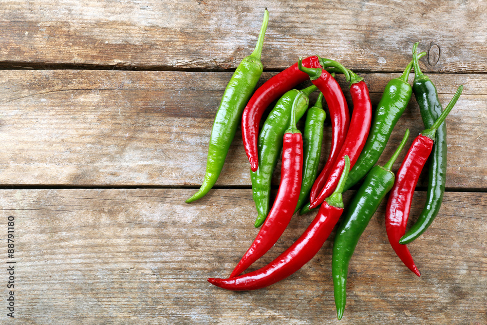 Hot peppers on wooden table close up