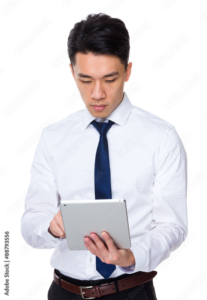 Asian young businessman use of the tablet pc Asian young businessman use of the tablet pc