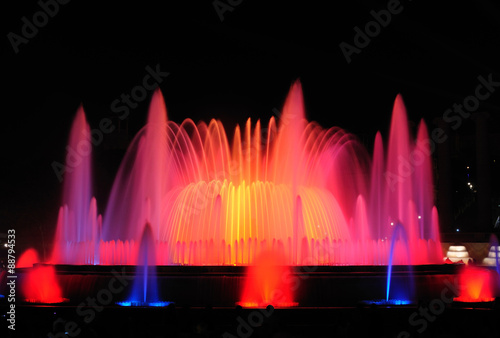 Night show of Magic Fountain of Montjuïc with different colors in Barcelona. Spain. 