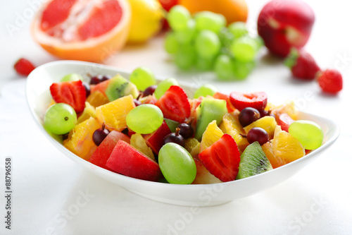 Fresh fruit salad on white wooden table