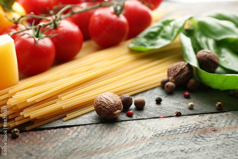 Pasta spaghetti with tomatoes, cheese and basil on rustic wooden background Pasta spaghetti with tomatoes, cheese and basil on rustic wooden background