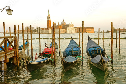 Gondolas moored by Saint Mark square with San Giorgio di Maggiore church in the background - Venice, Venezia, Italy, Europe