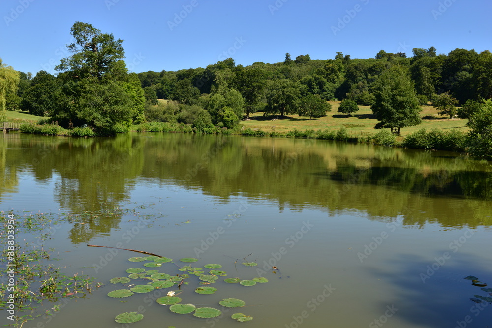 A lake at an English country estate in August,