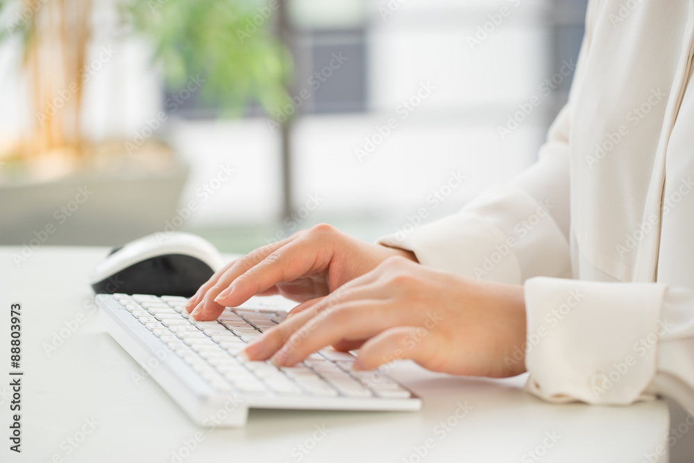 Hands of an office woman typing keyboard with credit card Hands of an office woman typing keyboard with credit card