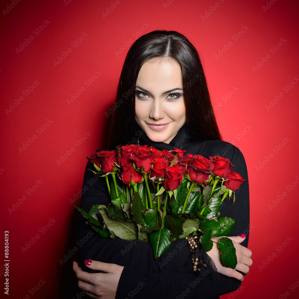 Beautiful Woman with Fresh Red Roses. Girl and Flowers over Red