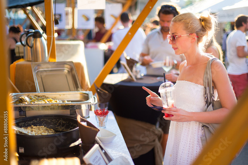 Woman buying a meal at food market. photo