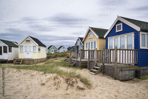 Lovely beach huts on sand dunes and beach landscape © veneratio