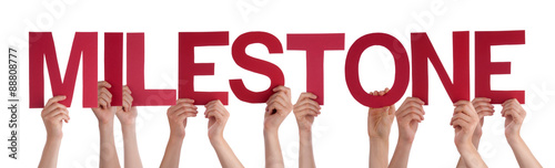 Many People Hands Holding Red Straight Word Milestone
