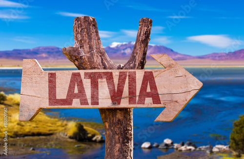Latvia wooden sign with a beautiful view on background photo