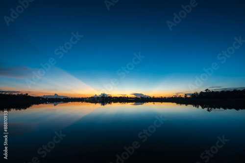 Fototapeta Naklejka Na Ścianę i Meble -  Sunset landscape with blue sky at the calm lake