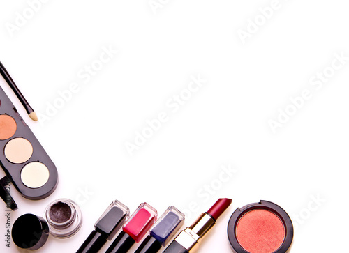 Set of professional cosmetic: make-up brushes, shadows, lipstick, nail polishes - partly isolated with shadows on white background. Overhead view. Front part. Place for your text.