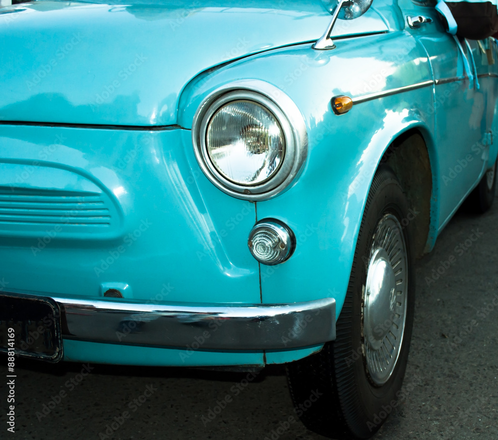 Turquoise skyey retro car closeup view from bottom position